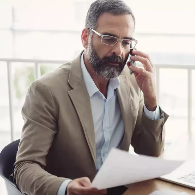 Man discussing Conga's Revenue Automation Suite on phone