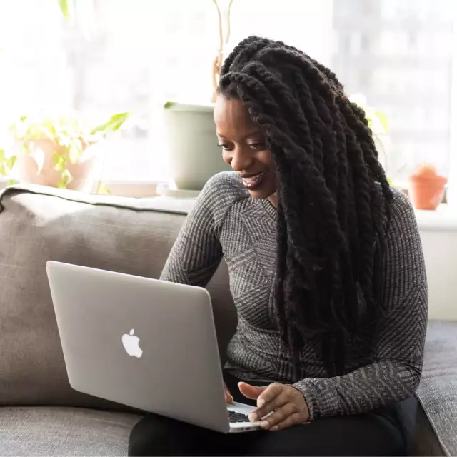 Woman smiling looking at laptop