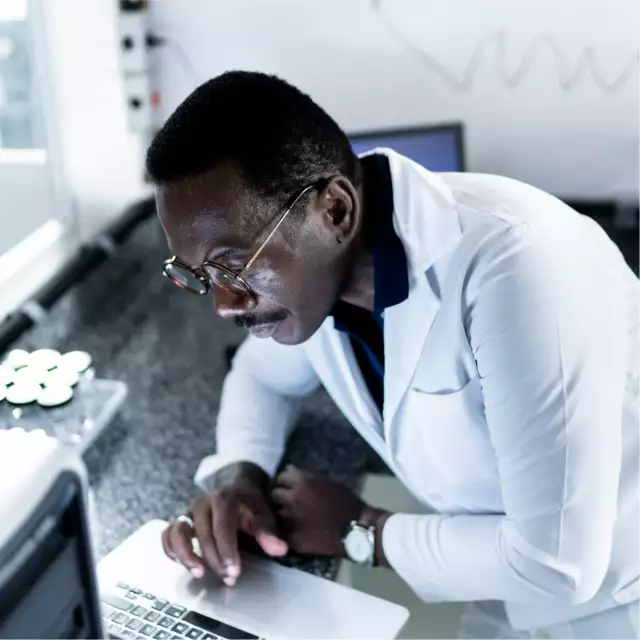 Man using laptop in lab