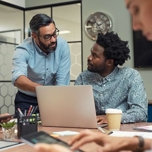 Two men looking at laptop