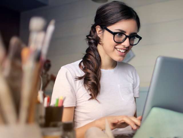 Woman smiling looking at laptop