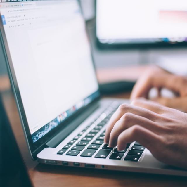 Closeup of person working on a word document on a laptop