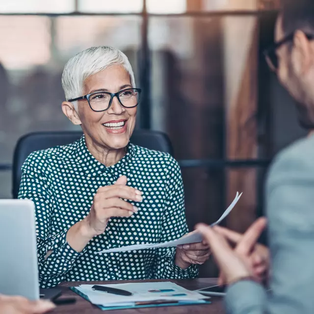 Older woman reviewing paperwork with man