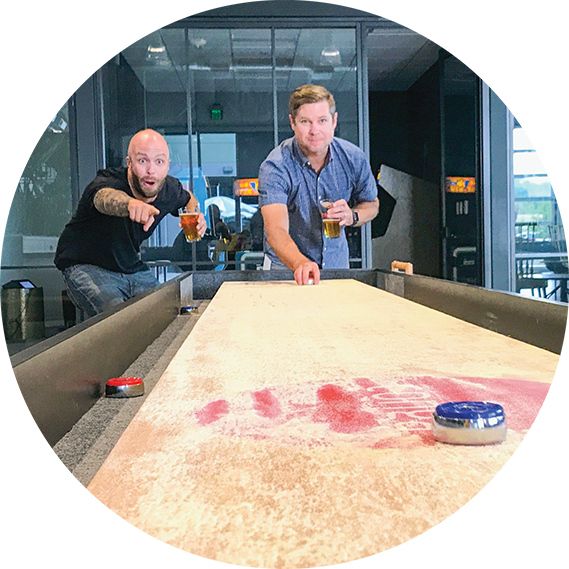 Conga employees playing shuffle board at the office