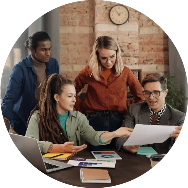 Four people looking over a document