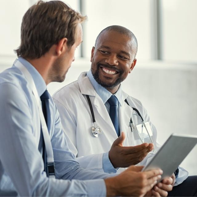 Two doctors smiling at each other
