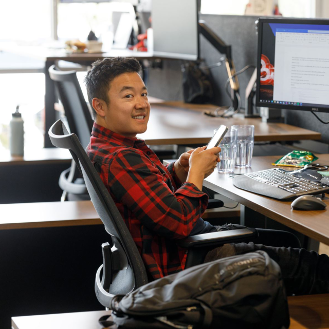 Conga employee smiling at desk