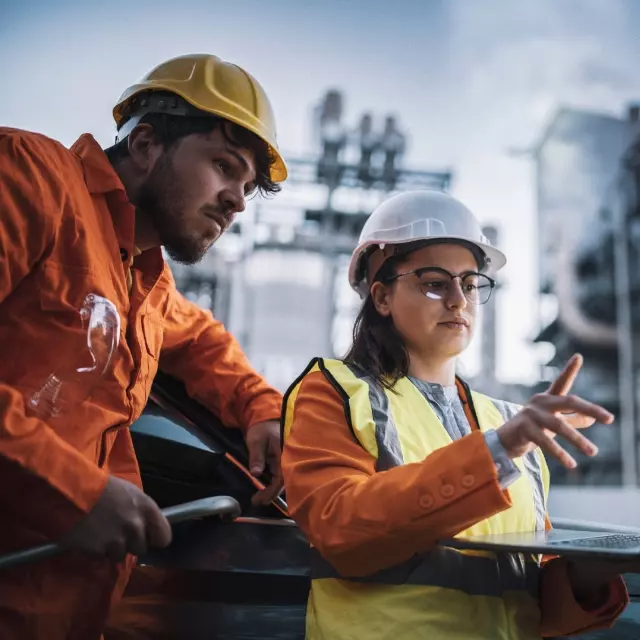 Energy workers looking at laptop