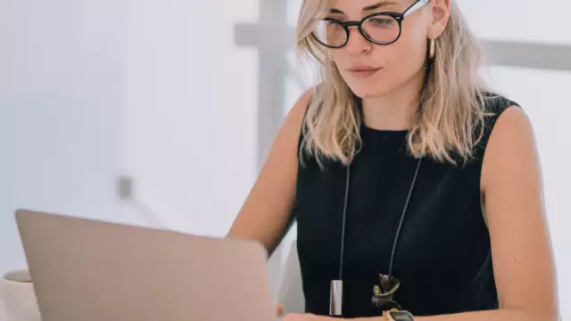 Woman working on laptop using Conga software