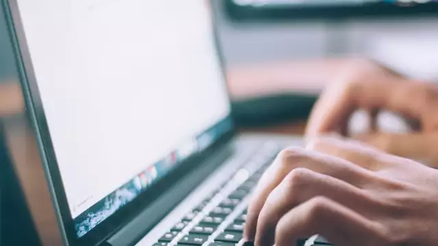 Closeup of person working on a word document on a laptop