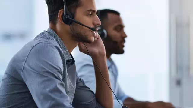 Two salesmen on headsets